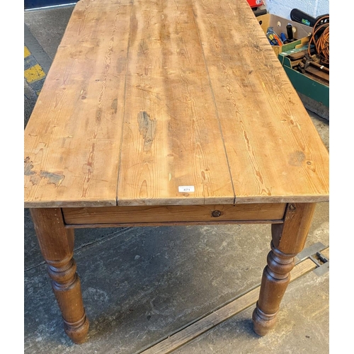 471 - Pine scrub-top kitchen table on baluster turned tapering legs. 150 x 85 x 77cm high approx. (B.P. 21... 