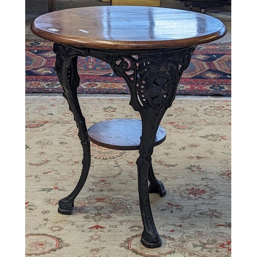 483 - Heavy cast iron pub type table with pierced cabriole legs and circular hardwood top and under-tier. ... 