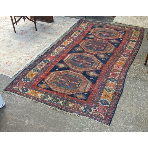 484 - Antique Caucasian rug, multi-coloured with four central medallions decorated with flowers and foliag... 