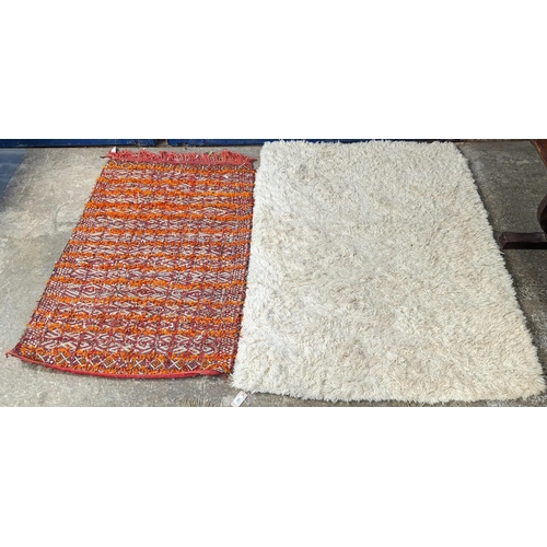 485 - Indian style beaded wall hanging and a cream shag pile rug. (2) (B.P. 21% + VAT)