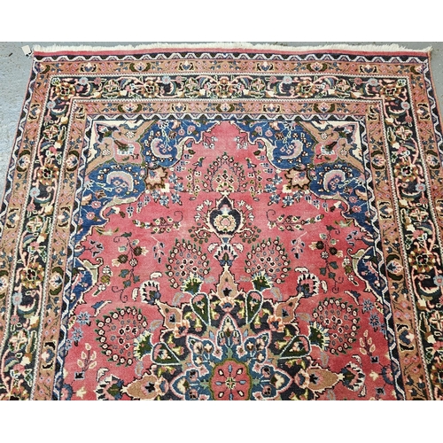 492 - Vintage Persian Heriz red ground floral and foliate carpet. 295 x 201cm approx. (B.P. 21% + VAT)