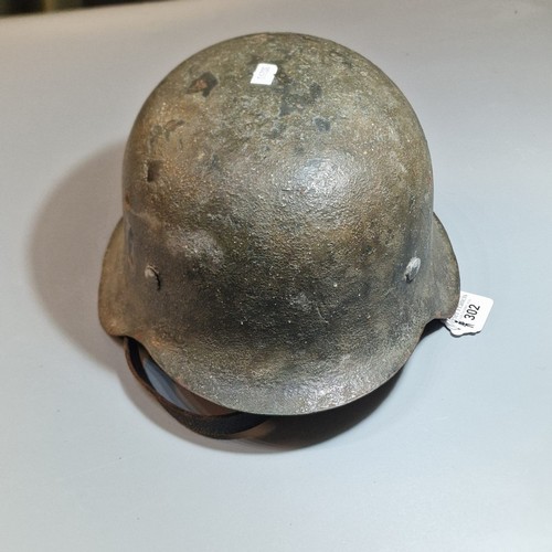 302 - German Third Reich M42 single decal helmet, with leather liner and chinstrap. Unclear markings stamp... 