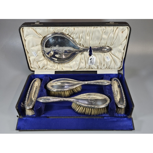 201 - George V five piece silver topped vanity set in original box comprising: four hand brushes and hand ... 