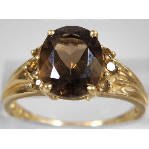 211 - 9ct gold brown stone dress ring. 2.7g approx. Size P.  (B.P. 21% + VAT)