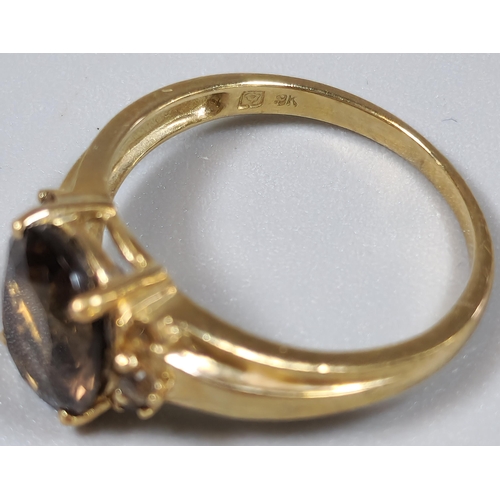 211 - 9ct gold brown stone dress ring. 2.7g approx. Size P.  (B.P. 21% + VAT)