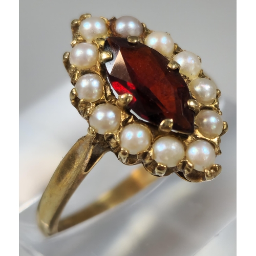 218 - 9ct gold pearl and red stone dress ring of oval form. 3.1g approx. Size. M1/2.  (B.P. 21% + VAT)