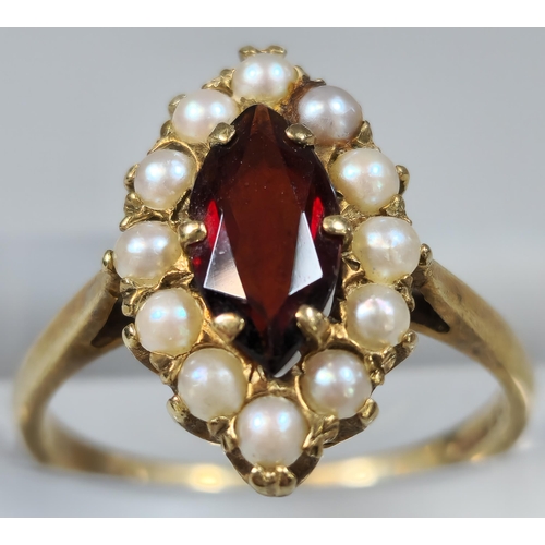 218 - 9ct gold pearl and red stone dress ring of oval form. 3.1g approx. Size. M1/2.  (B.P. 21% + VAT)