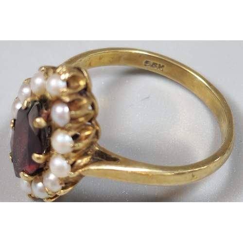 218 - 9ct gold pearl and red stone dress ring of oval form. 3.1g approx. Size. M1/2.  (B.P. 21% + VAT)