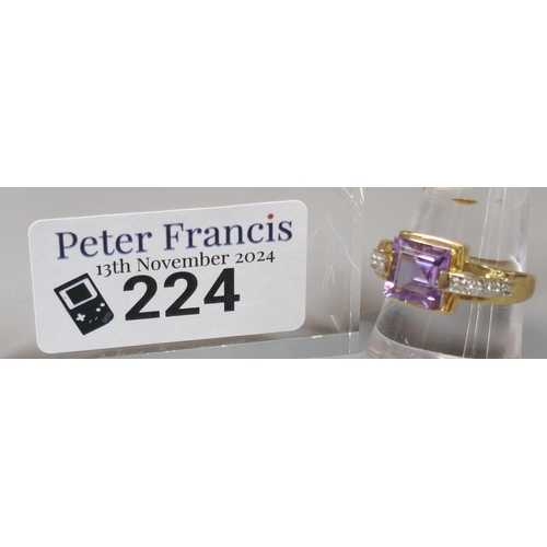 224 - 9ct purple and clear stone dress ring. 3.3g approx. Size O1/2.  (B.P. 21% + VAT)