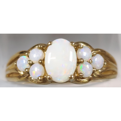 225 - 9ct gold seven stone opal dress ring. 1.8g approx. Size M1/2.  (B.P. 21% + VAT)