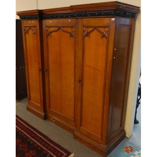 535 - Victorian Gothic design oak break front three section wardrobe, having moulded and carved and pierce... 