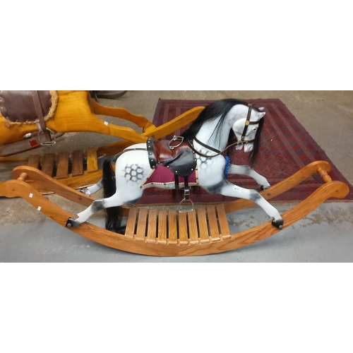 551 - 20th century painted carousel type rocking horse with natural mane and tail, leather saddle and brid... 