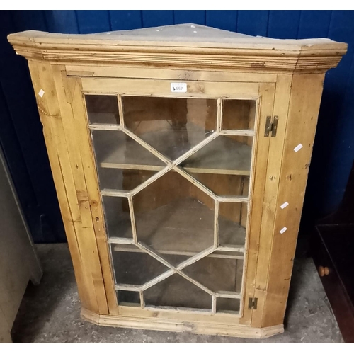 557 - Early 19th century natural pine hanging corner cabinet with astragal glazed door and fitted shelves.... 