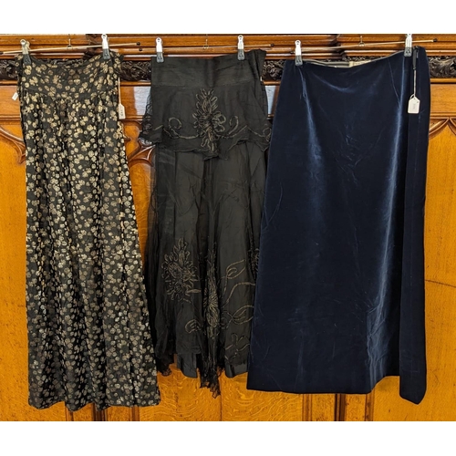 601 - Blue velvet skirt labelled 'Made for Cresta', together with two other skirts, one with floral decora... 