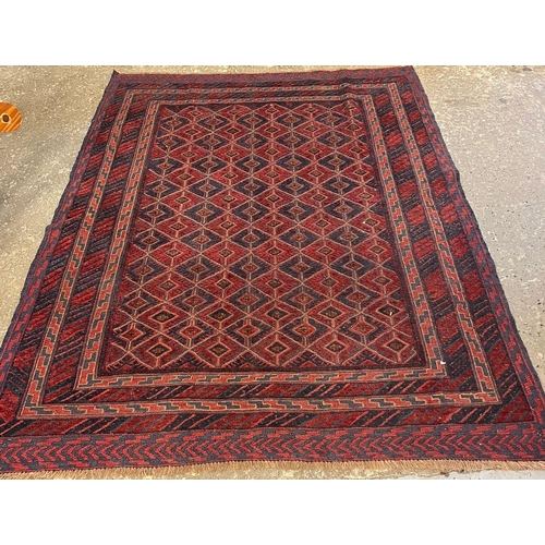 607 - Afghan Mushwani red and blue ground geometric rug. 198x152cm approx. (B.P. 21% + VAT)