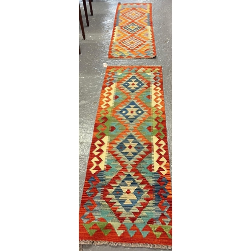 612 - Two similar Afghan geometric multi-coloured veg dye Kilim runners. 155x53cm and 144x49cm approx. (2)... 