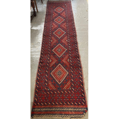 613 - Middle Eastern design red and blue ground runner with repeating lozenge panels and geometric borders... 