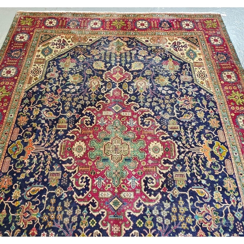 614 - Middle Eastern dark blue ground foliate carpet with repeating flowerhead borders. 340x242cm approx. ... 