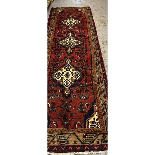 615 - Persian Hamadan runner, with three central medallions, stylised flowers and geometric borders. 310x8... 