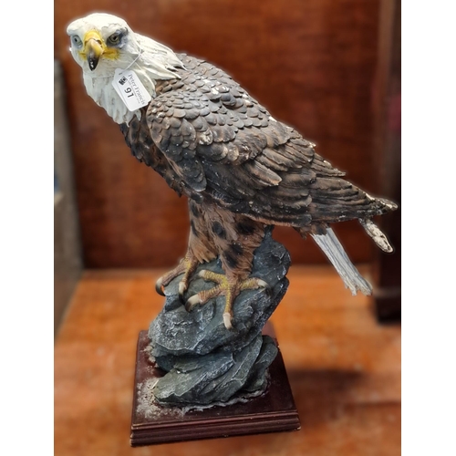 91 - Modern composition study of an American Bald Eagle on naturalistic rock-work and mahogany finish bas... 