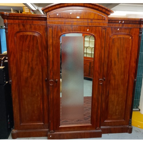 591 - Victorian mahogany break front wardrobe, having arched pediment over centre glazed door revealing fi... 