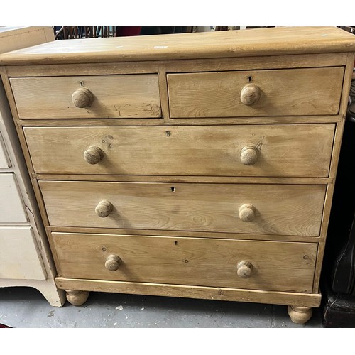 494 - Victorian stripped pine straight fronted chest of two short and three long graduated drawers on balu... 