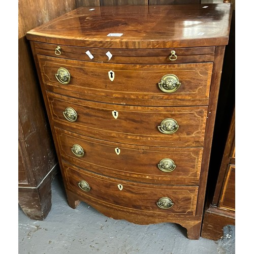 501 - George III mahogany bow fronted narrow chest of four drawers under a brushing slide, with shield sha... 