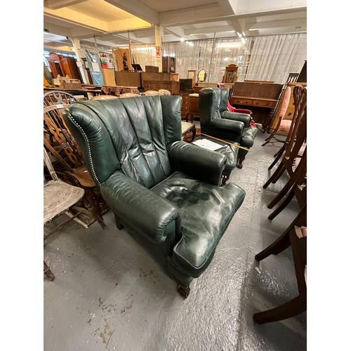 515 - Pair of modern deeply upholstered leather semi-wing easy chairs, with loose cushions and ball and cl... 