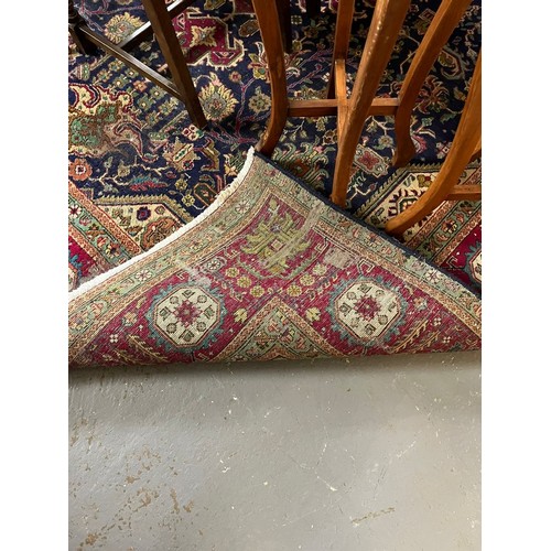 614 - Middle Eastern dark blue ground foliate carpet with repeating flowerhead borders. 340x242cm approx. ... 