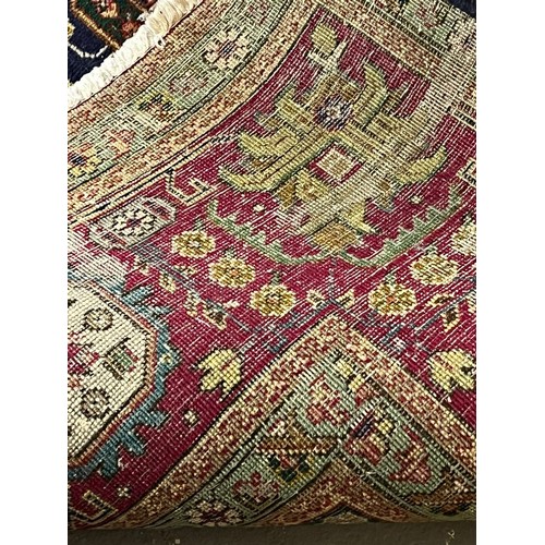 614 - Middle Eastern dark blue ground foliate carpet with repeating flowerhead borders. 340x242cm approx. ... 