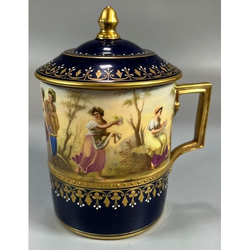 134 - Late 19th early 20th century Vienna porcelain chocolate cup and cover on a gilded and cobalt blue gr... 