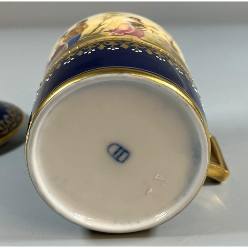 134 - Late 19th early 20th century Vienna porcelain chocolate cup and cover on a gilded and cobalt blue gr... 