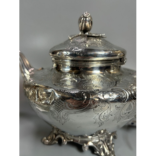 153 - Victorian three piece tea service, ornately engraved, to include: baluster teapot with bud finial, t... 