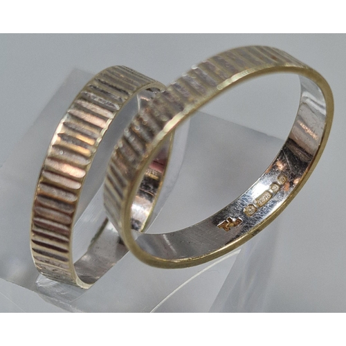 185 - Two 9ct white gold engraved wedding rings, hallmarked for London 1978. 4g approx. Size N and P. (B.P... 