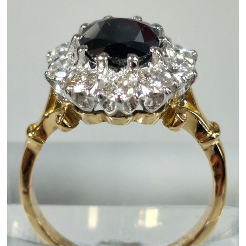 211 - 18ct gold diamond and sapphire ring, the central facetted oval sapphire stone surrounded by ten diam... 