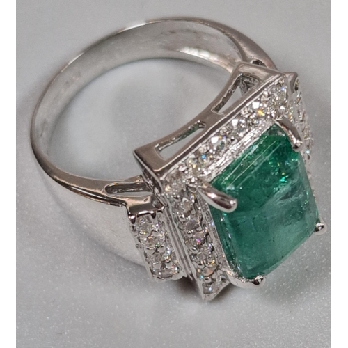 216 - 18ct white gold Art Deco style diamond and emerald ring, the central rectangular facetted emerald su... 