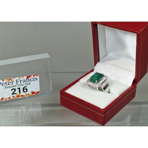 216 - 18ct white gold Art Deco style diamond and emerald ring, the central rectangular facetted emerald su... 