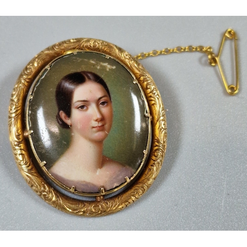 219 - 19th century yellow metal framed brooch of oval form, the ceramic hand-painted panel with a portrait... 