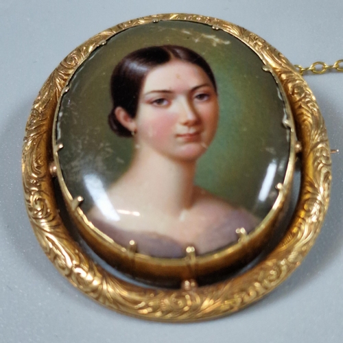 219 - 19th century yellow metal framed brooch of oval form, the ceramic hand-painted panel with a portrait... 