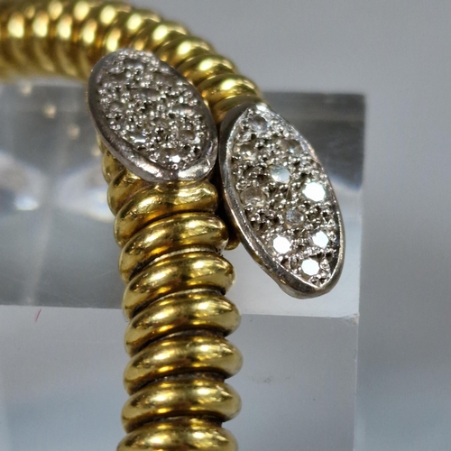 223 - Yellow metal spiral link hollow bracelet, with a crossover section at the front comprising two oval ... 