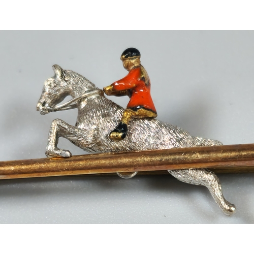 226 - 14ct gold novelty brooch in the form of a riding whip/crop with huntsman on horse. 7.3g approx. (B.P... 