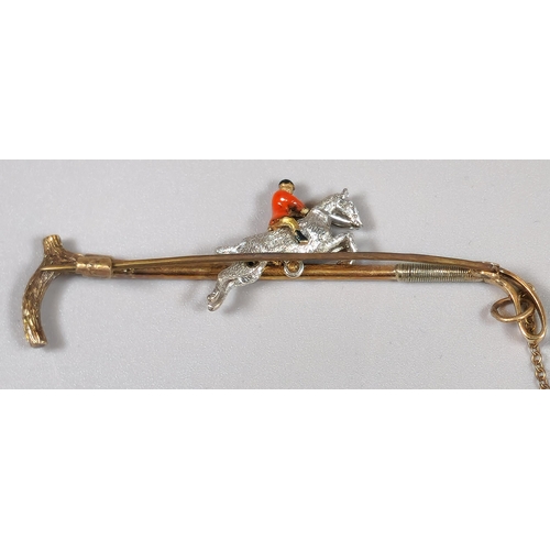 226 - 14ct gold novelty brooch in the form of a riding whip/crop with huntsman on horse. 7.3g approx. (B.P... 