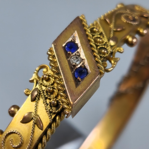 228 - Late Victorian 9ct gold ladies' bangle inset with two sapphires and one diamond. Chester 1900, in or... 