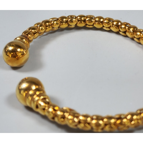 229 - 9ct gold ladies' torque bangle. In probably original box. 11.4g approx. (B.P. 21% + VAT)