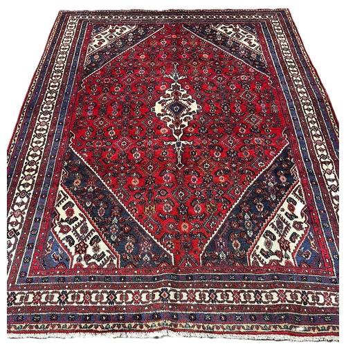 312 - Hand woven red ground Persian Surak Village carpet with traditional diamond medallion design. 320x21... 