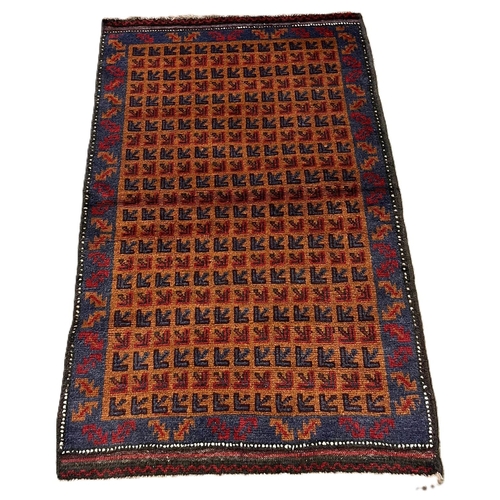 313 - Rust ground Afghan Beluchi nomadic rug with all over repeating designs. 140x90cm approx.  (B.P. 21% ... 