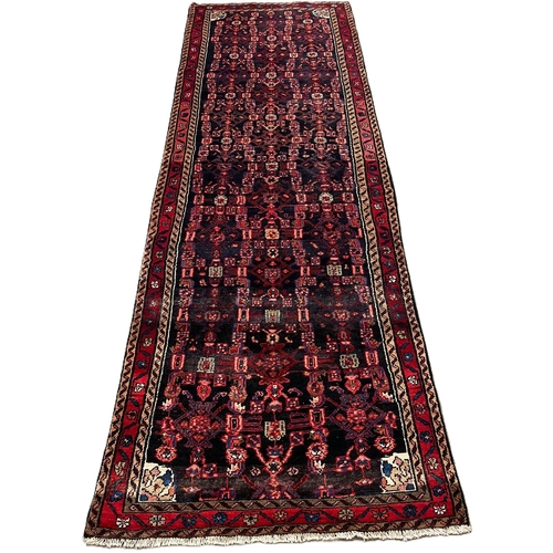 316 - Black ground full pile hand woven Persian runner. 302x110cm approx.  (B.P. 21% + VAT)