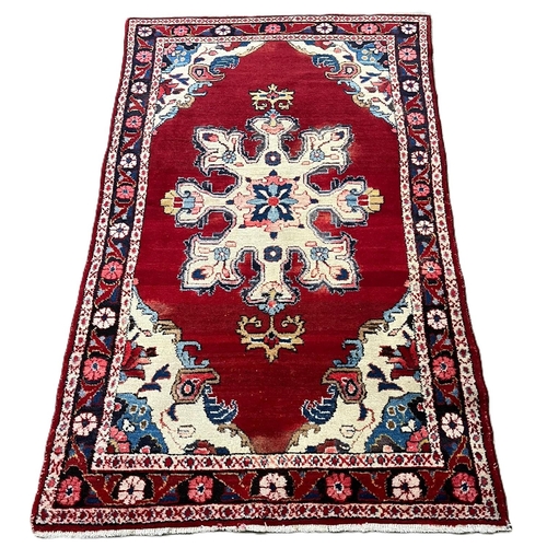 318 - Rich red ground hand woven Persian Village rug with medallion design. 203x120cm approx.  (B.P. 21% +... 