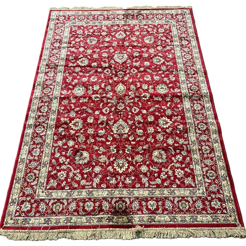 326 - Red ground full pile Kasmir rug, with all over floral designs. (B.P. 21% + VAT)