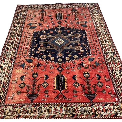 330 - Middle Eastern/Moroccan design hand woven red ground carpet, with central medallion, repeating styli... 